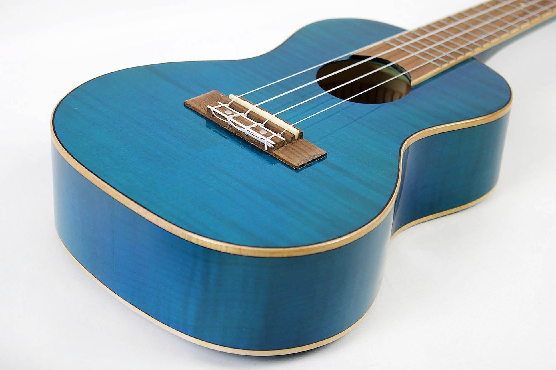 This is the front side view of the top and neck of an Amahi PGUK555BLC Flamed Maple Concert Ukulele- blue.