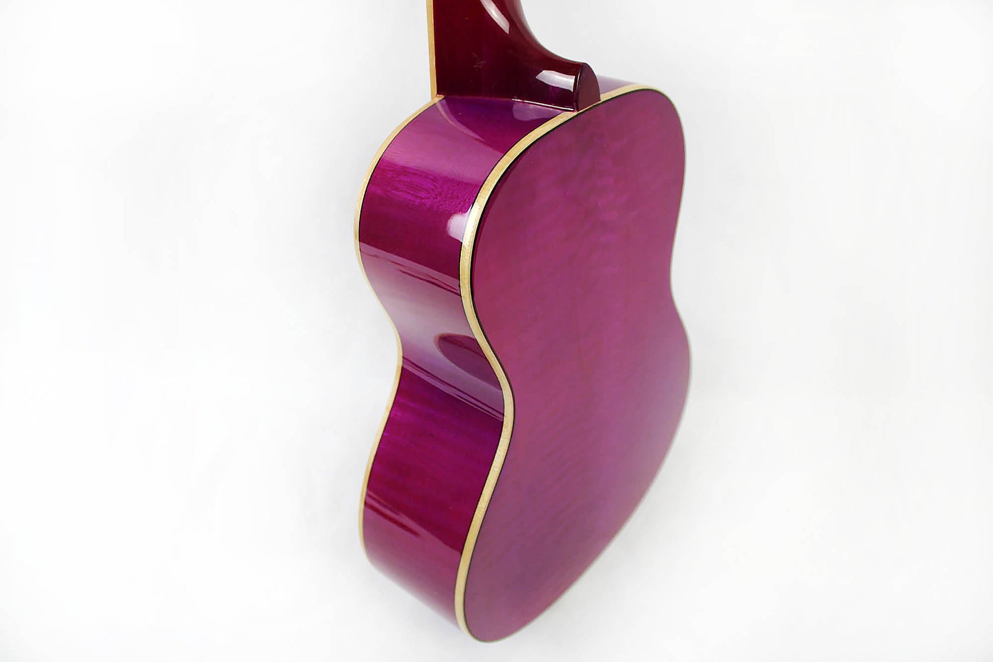 This is the back of the body and neck of an Amahi PGUK555PUC Flamed Maple Concert Ukulele- purple.