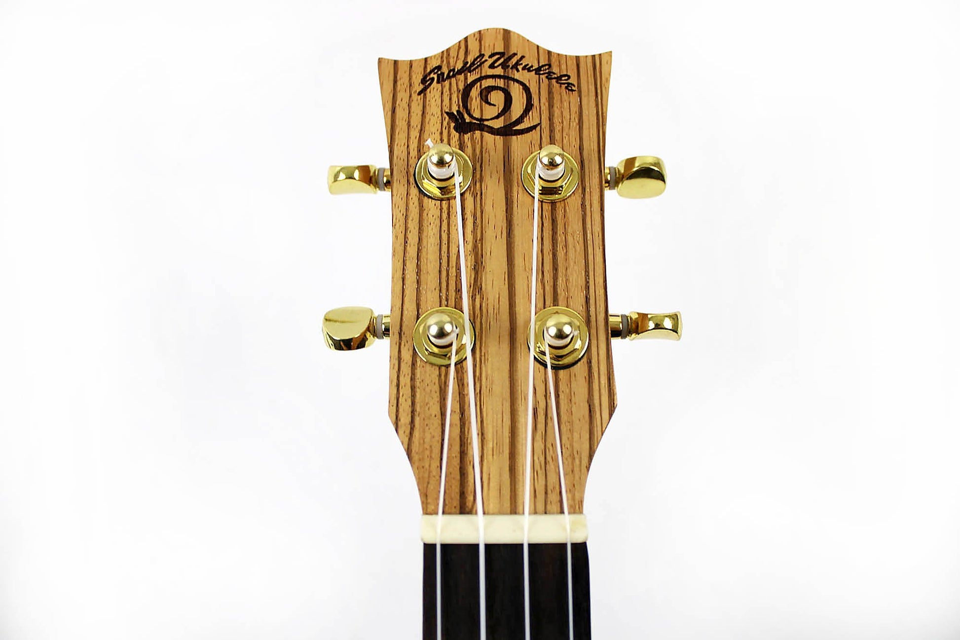 This is the front of the headstock of a Snail SNAILZEBUKT Zebrawood Tenor Ukulele.